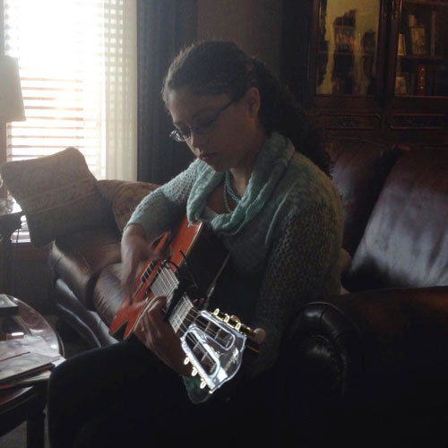 Cara playing guitar